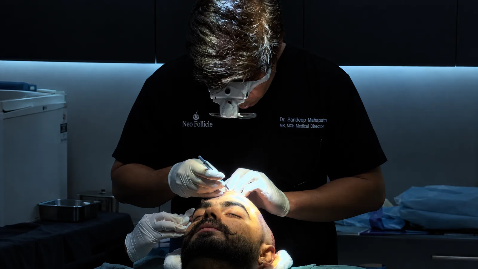 A Neo Follicle surgeon performing a hair transplant procedure on a patient.